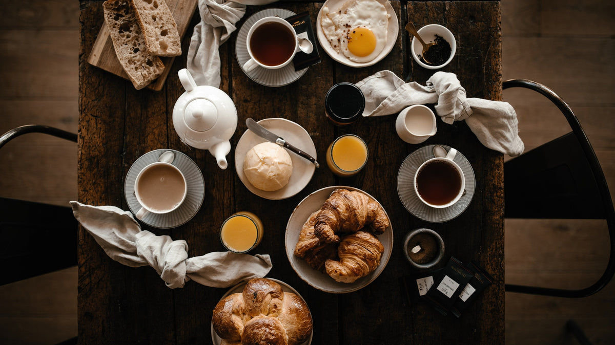 Breakfast table with Dammann Frères tea, croissants and brioche, seen from above