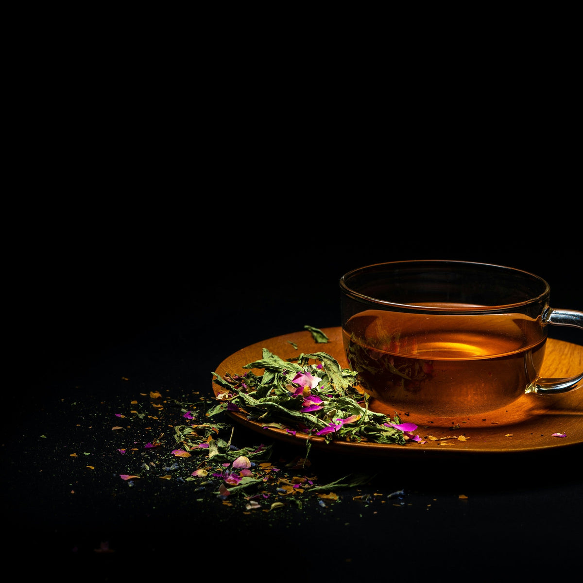 Cup of tea on a saucer with dried flowers