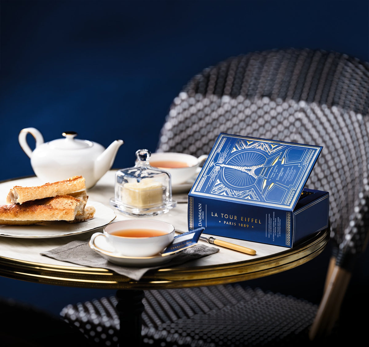 Coffret Tour Eiffel de Dammann Frères sur une table de bistrot parisien