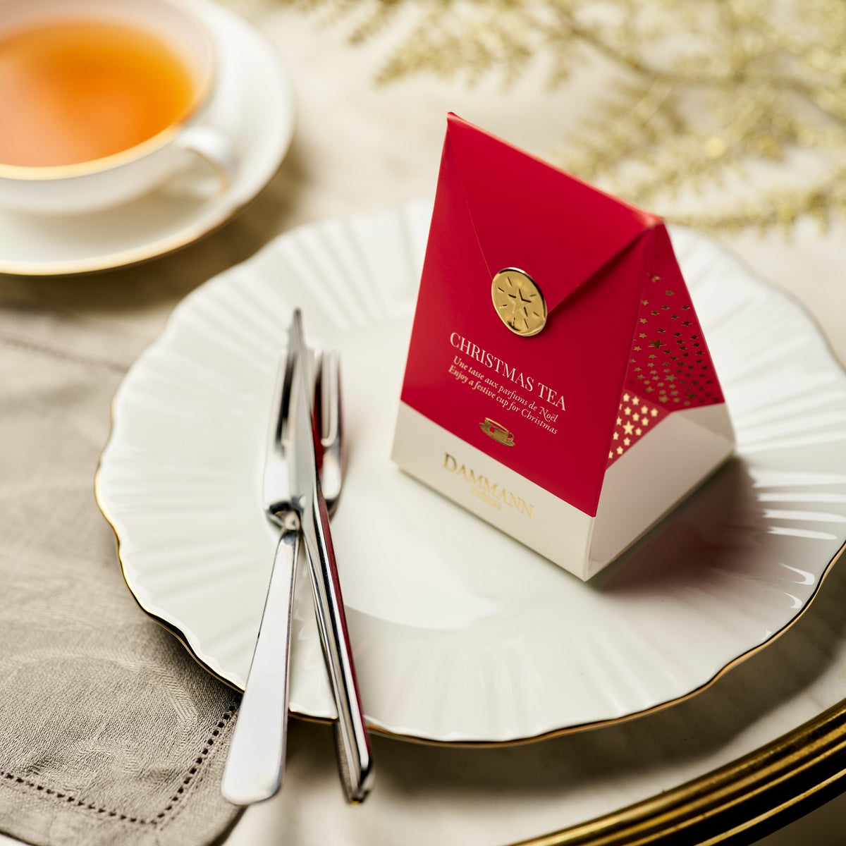 Dammann Frères Christmas Tea red pocket on a festive table setting