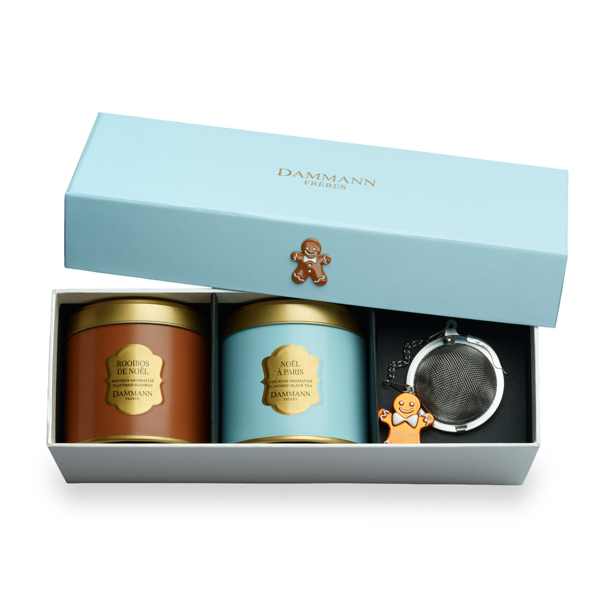 Coffret Noël Givré de Dammann Frères, boîte ouverte avec deux boîtes de thé et un infuseur bonhomme en pain d’épices