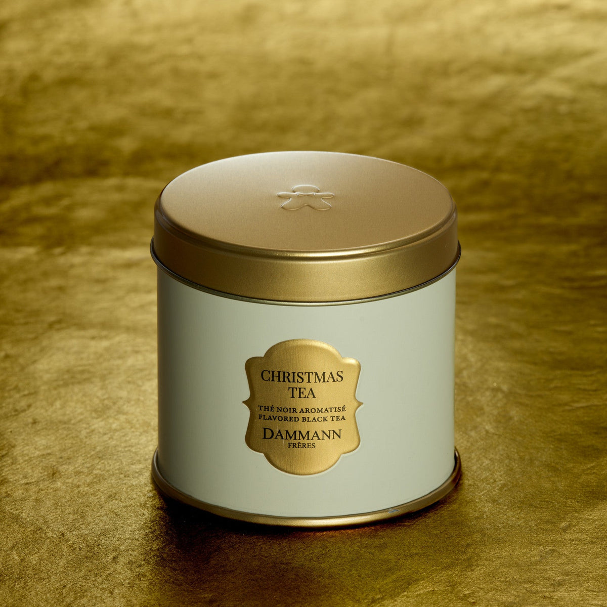 Christmas Tea by Dammann Frères, white and gold tin on a gold background