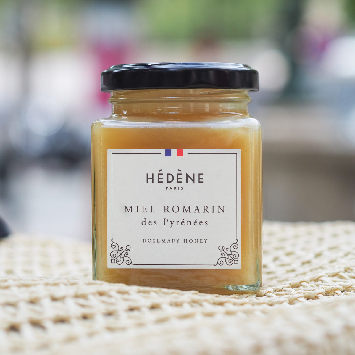 Hédène Pyrénées rosemary honey jar on a woven cloth