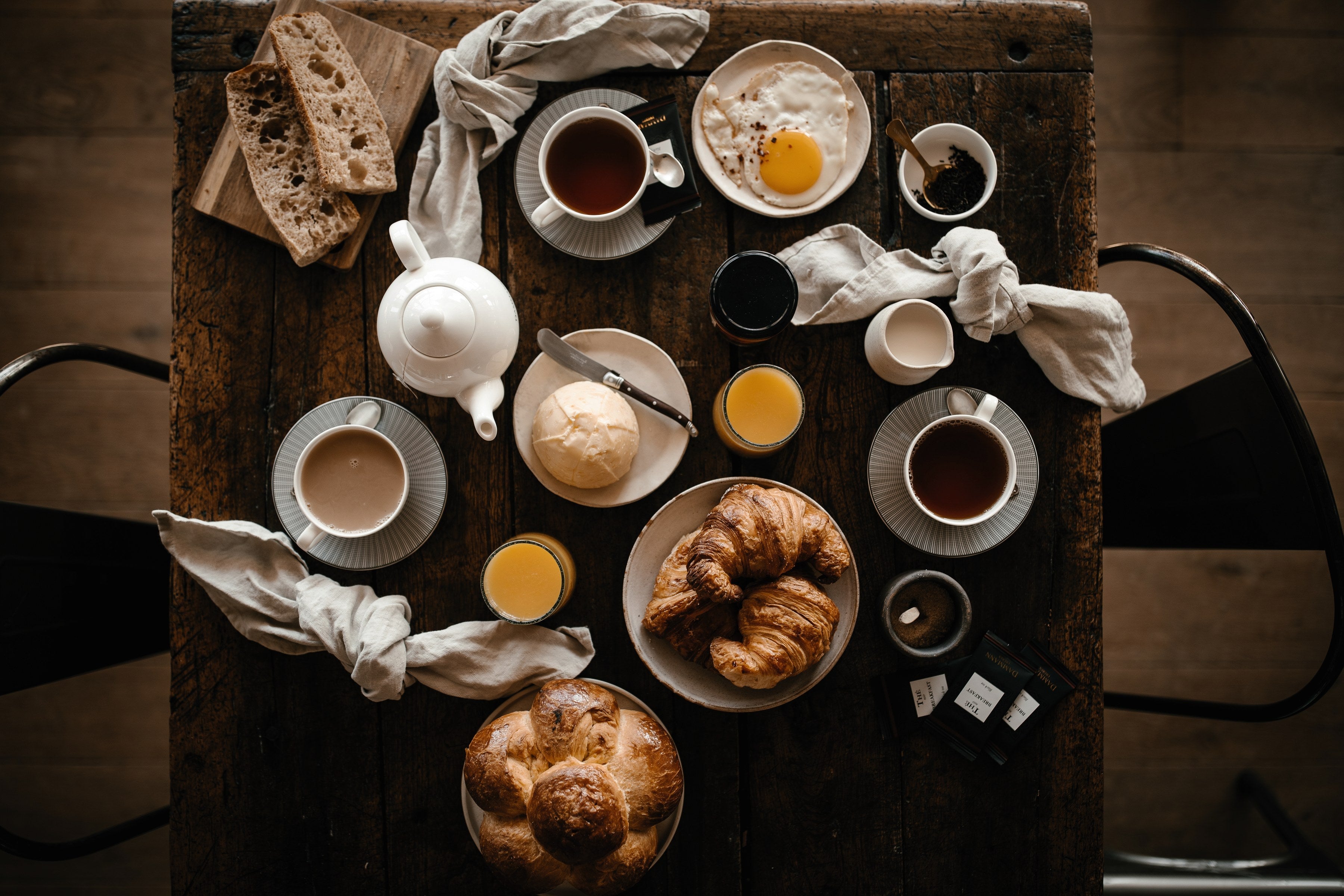 Breakfast table with Dammann Frères tea, croissants and brioche, seen from above
