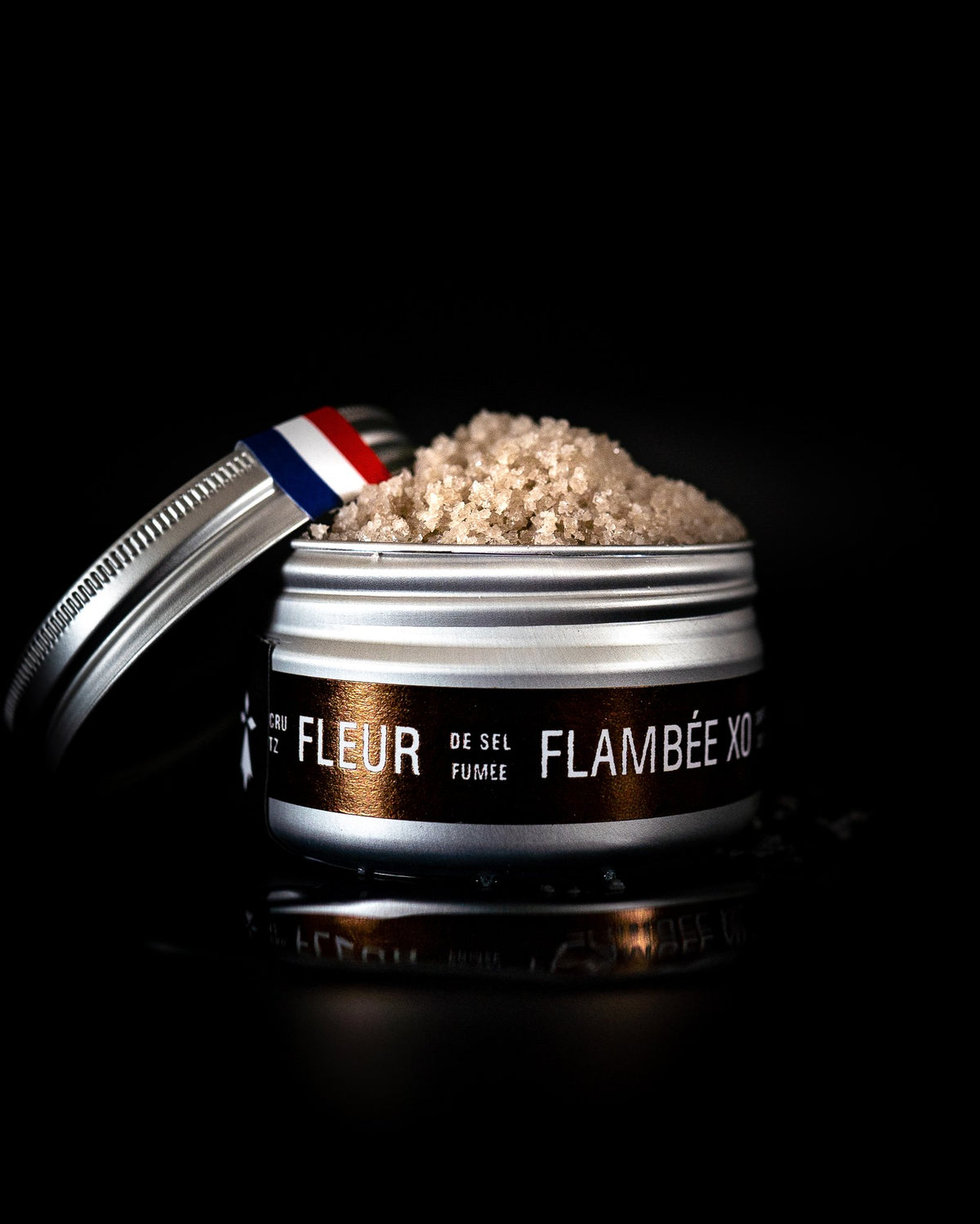 Binet 1660 fleur de sel flamed with XO Cognac, tin on a black background