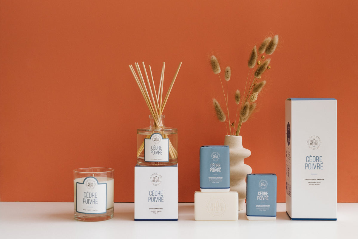 Cedarwood Candle by La Belle Mèche with its box, alongside the matching diffuser and soaps from the same scent range