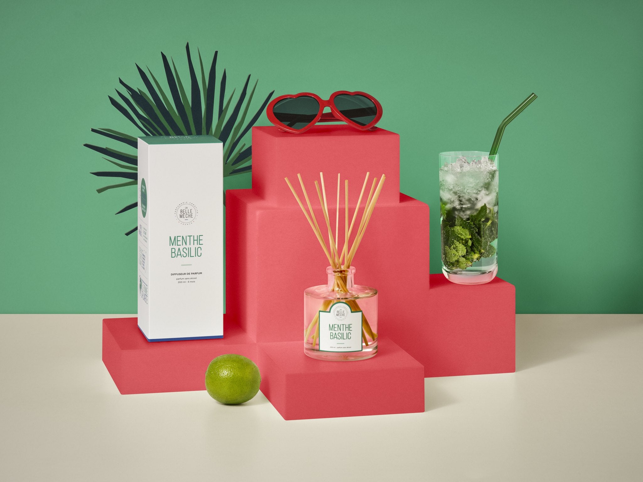 La Belle Mèche Mint Basil reed diffuser beside a mojito
