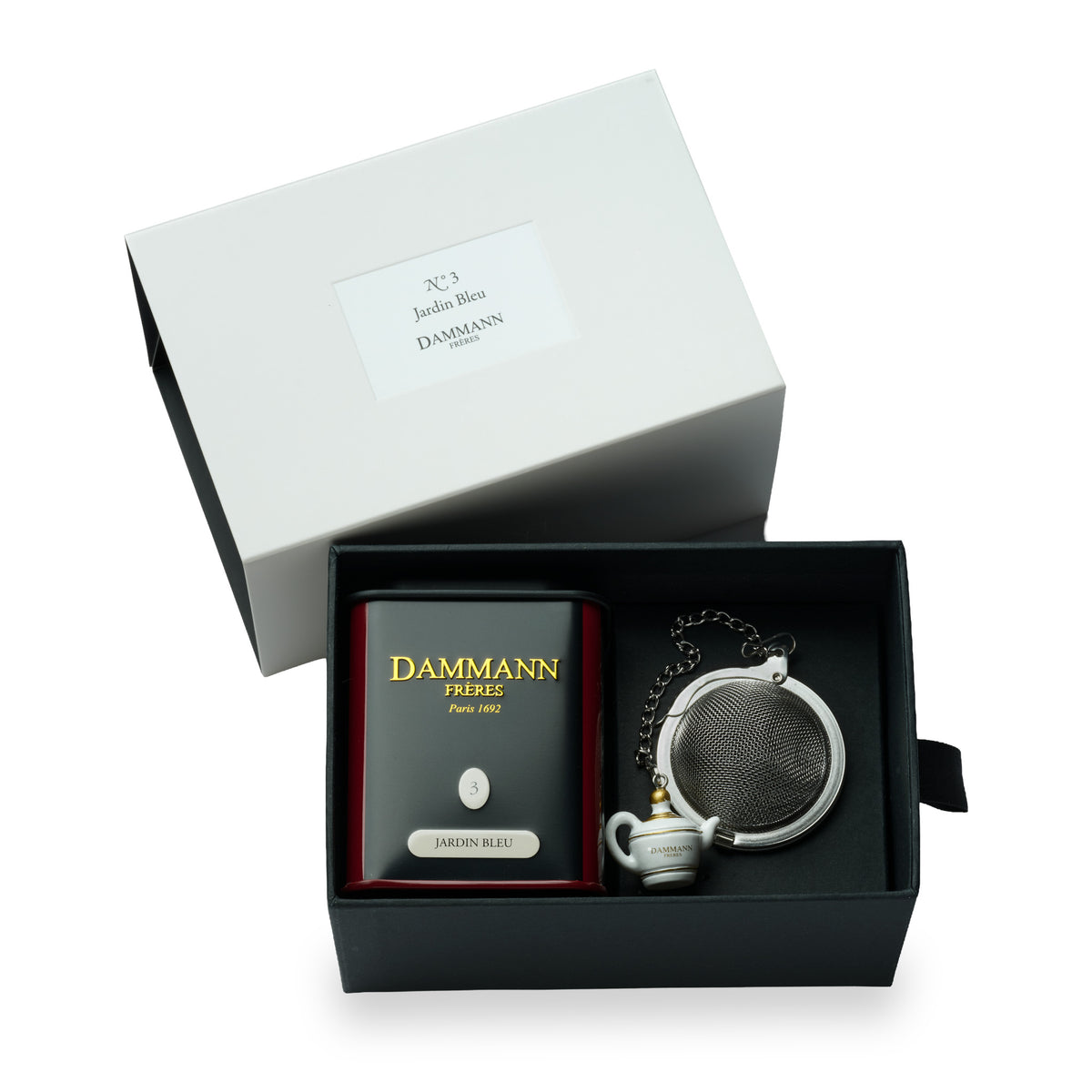 N°3 Jardin Bleu gift box by Dammann Frères, open with a tea tin and a tea ball infuser