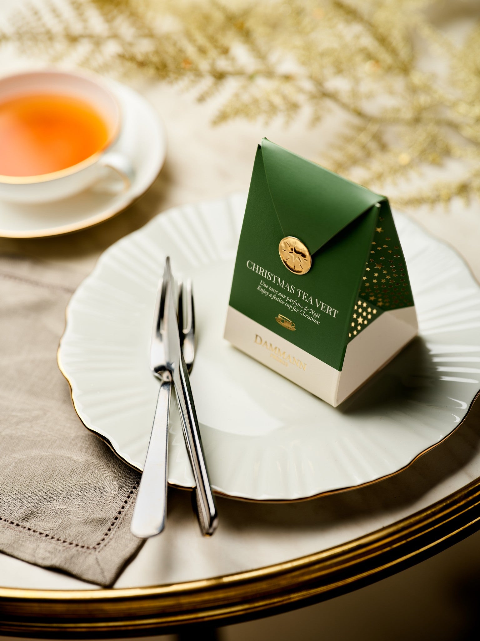 Dammann Frères Christmas Tea Vert pocket on a festive table setting