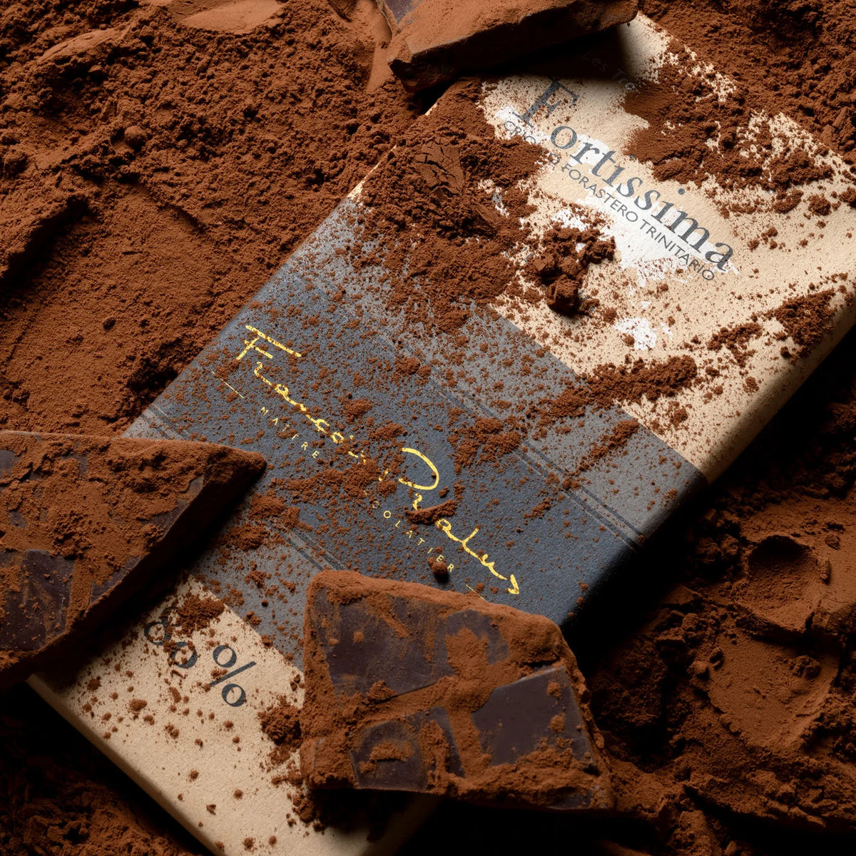 Fortissima 80% Dark Chocolate Bar by François Pralus on cocoa powder