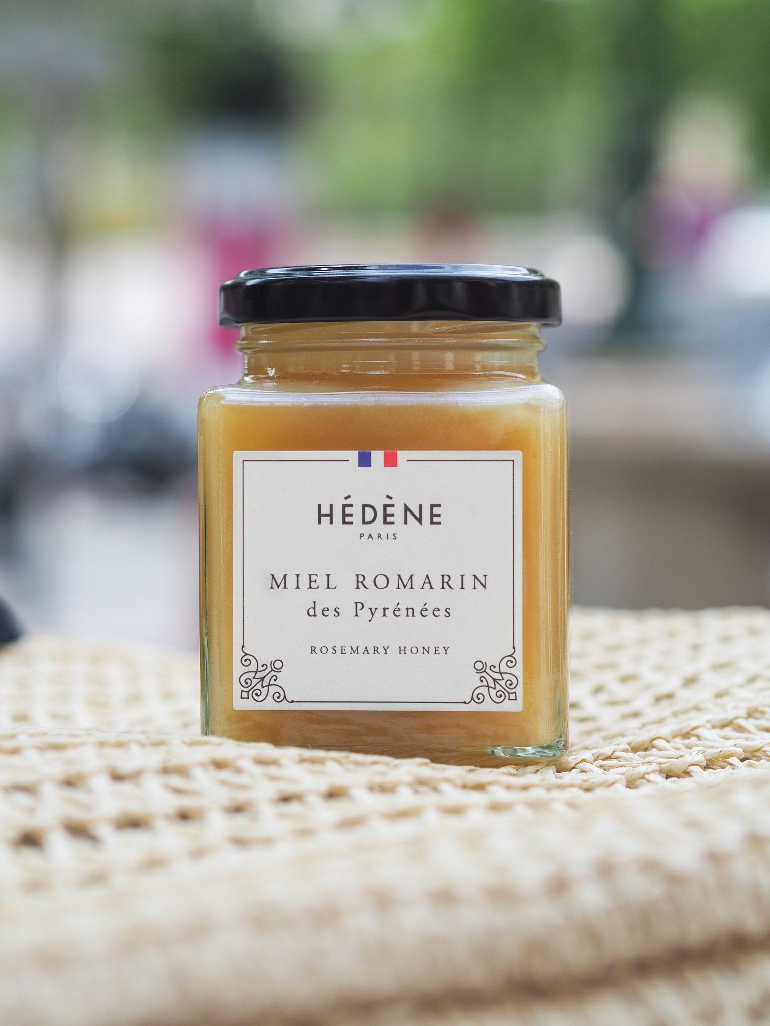 Hédène Pyrénées rosemary honey jar on a woven cloth