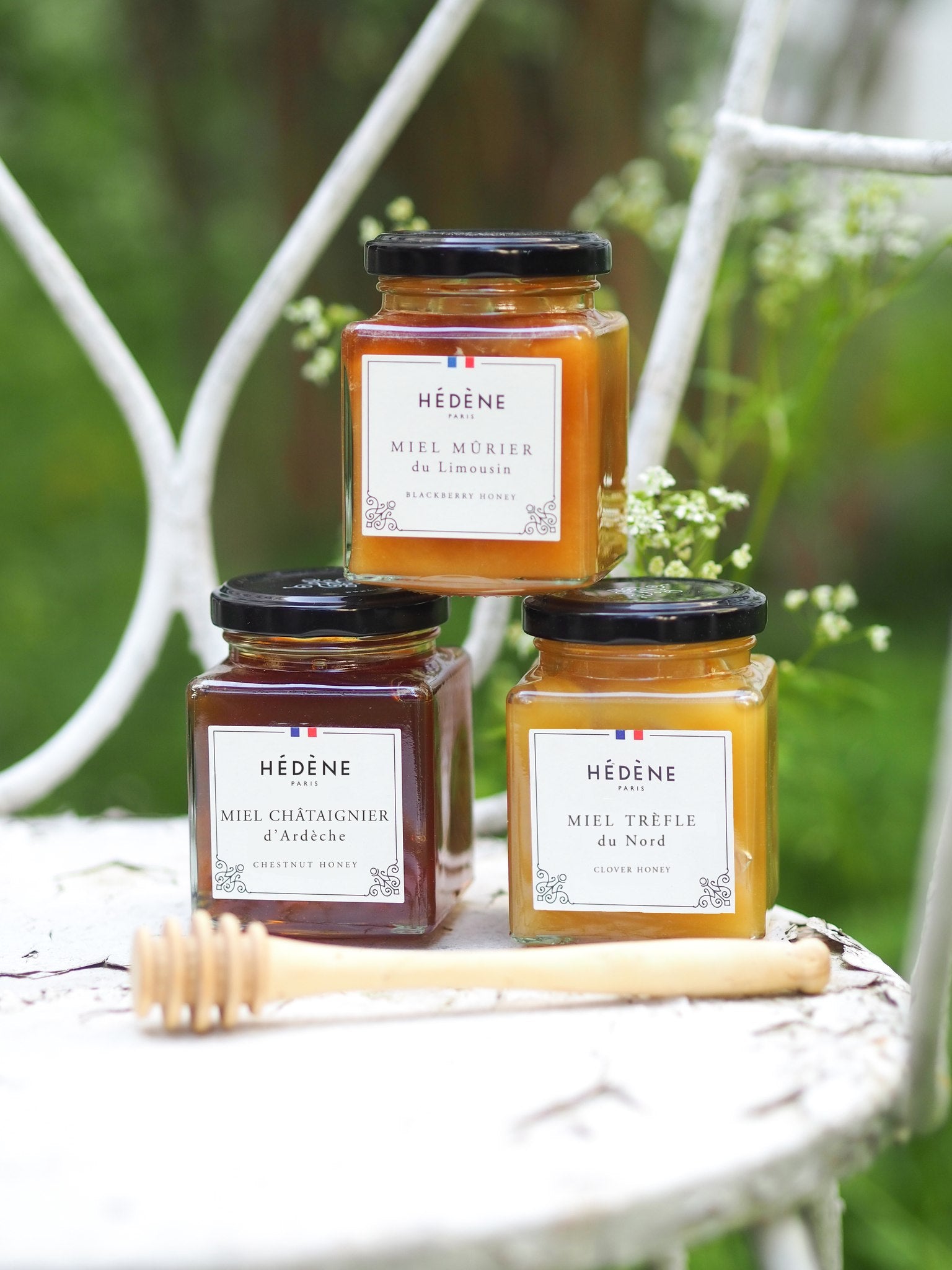 Hédène blackberry, chestnut and clover honey jars on a white garden chair