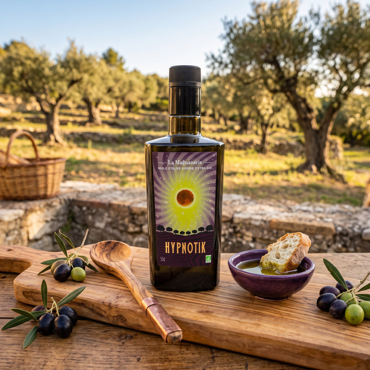 La Magnanerie Hypnotik organic olive oil on a board with olives and bread