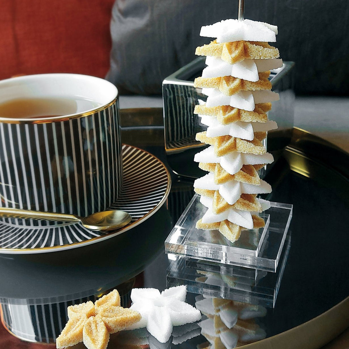 Canasuc La Tour d'Embellie stacked star sugars beside a cup of tea
