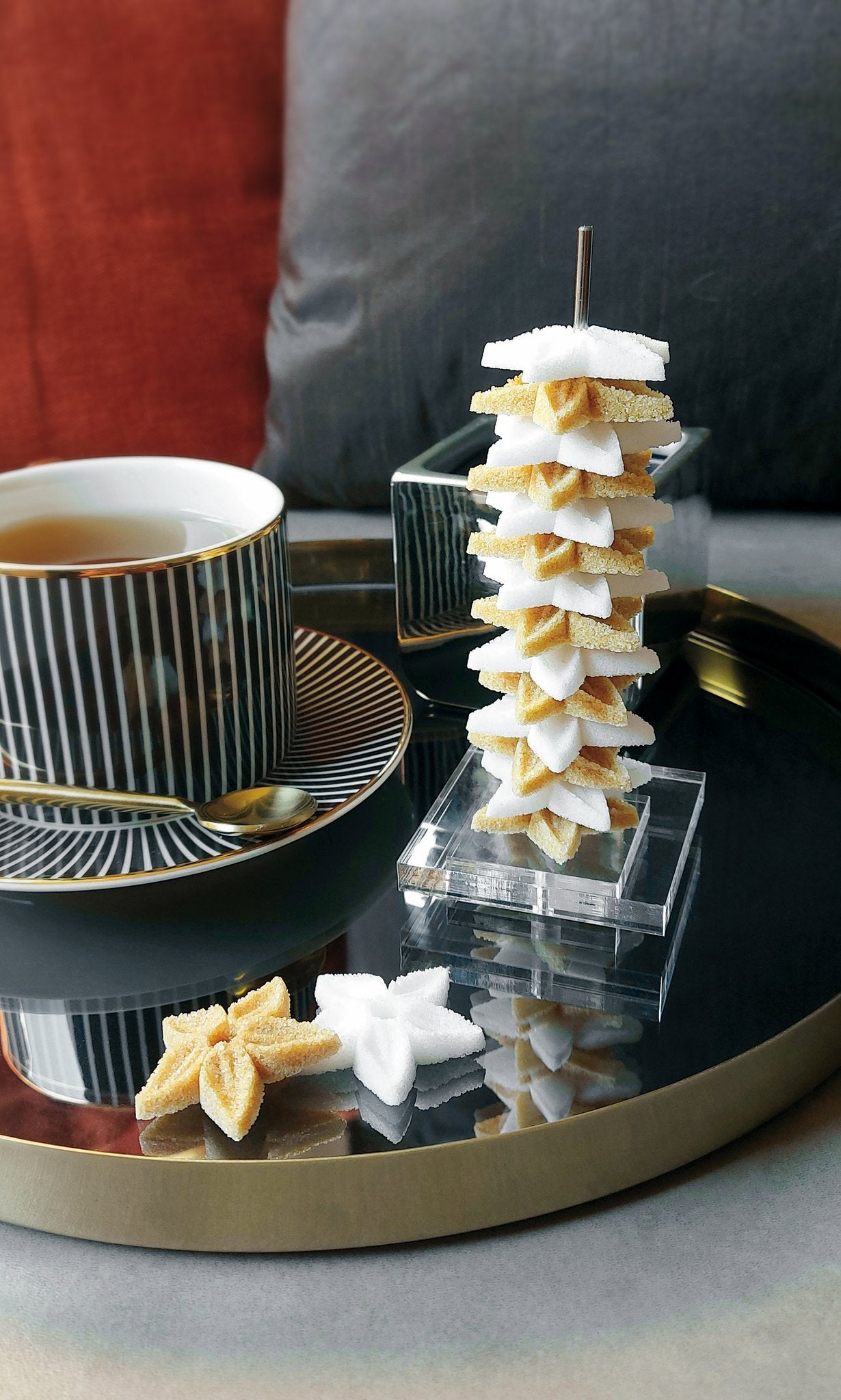 Canasuc La Tour d'Embellie stacked star sugars beside a cup of tea