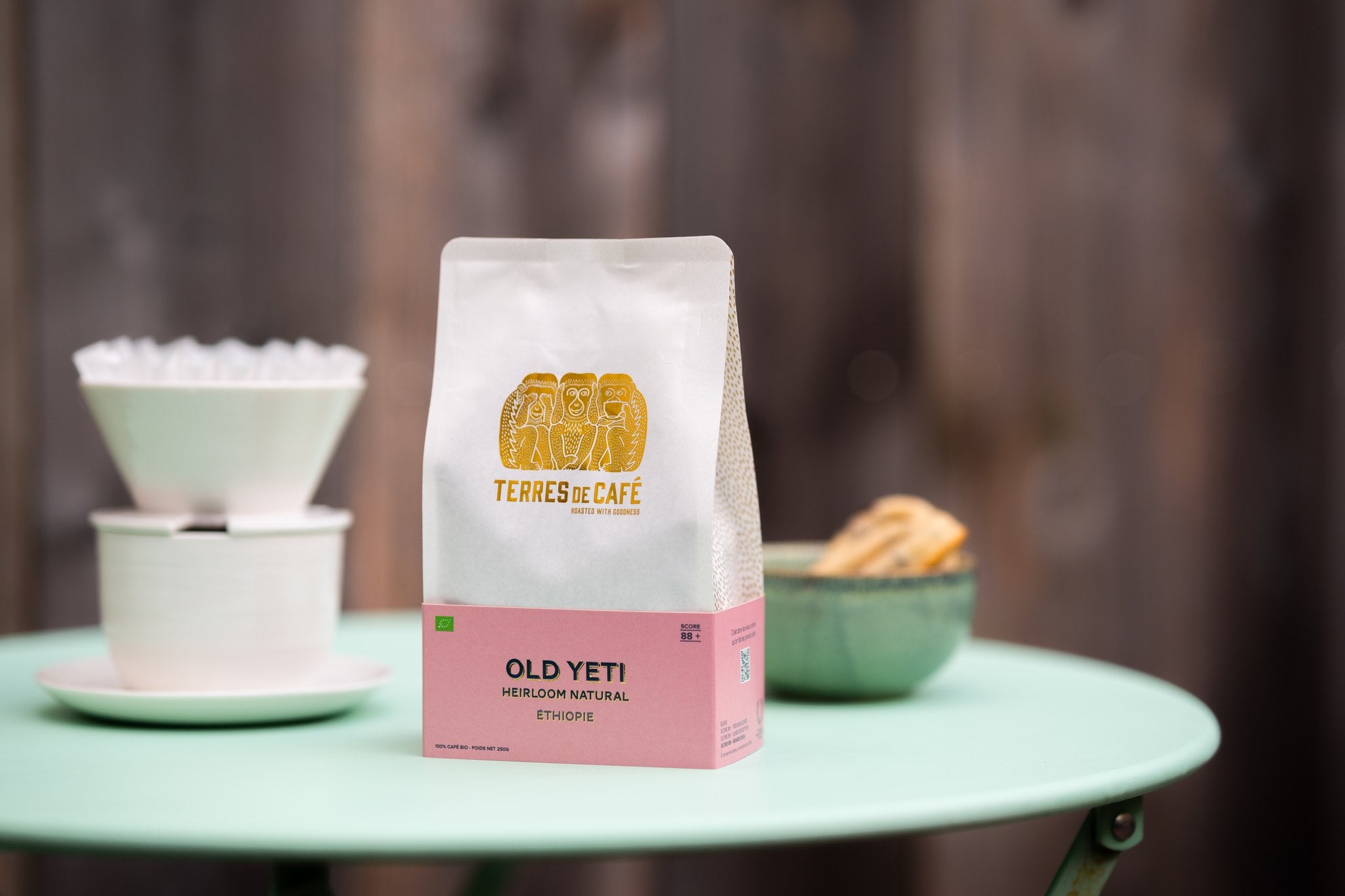 Terres de Café Old Yeti coffee on a café table with a pour-over dripper